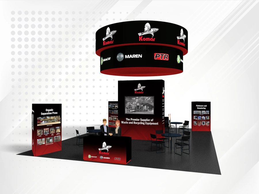 A large trade show booth design with a hanging sign, tall displays, and a counter